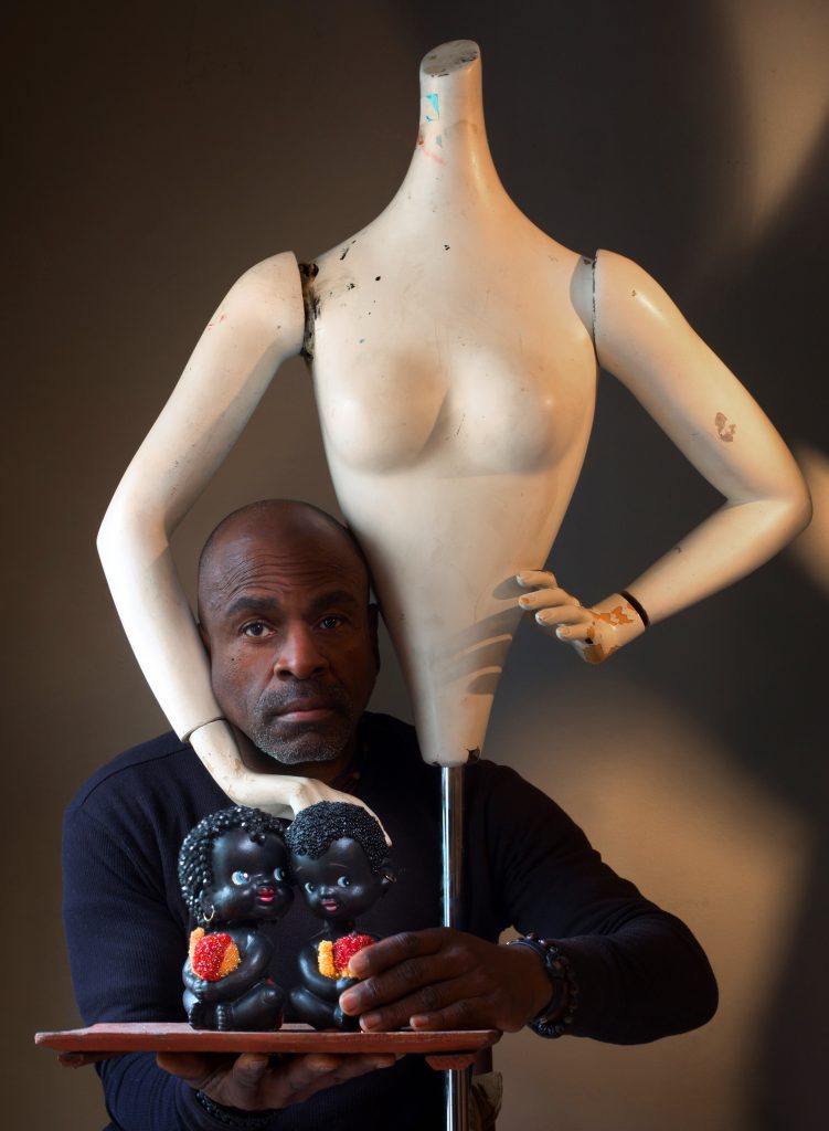 Willie Little with nodder dolls and a mannequin